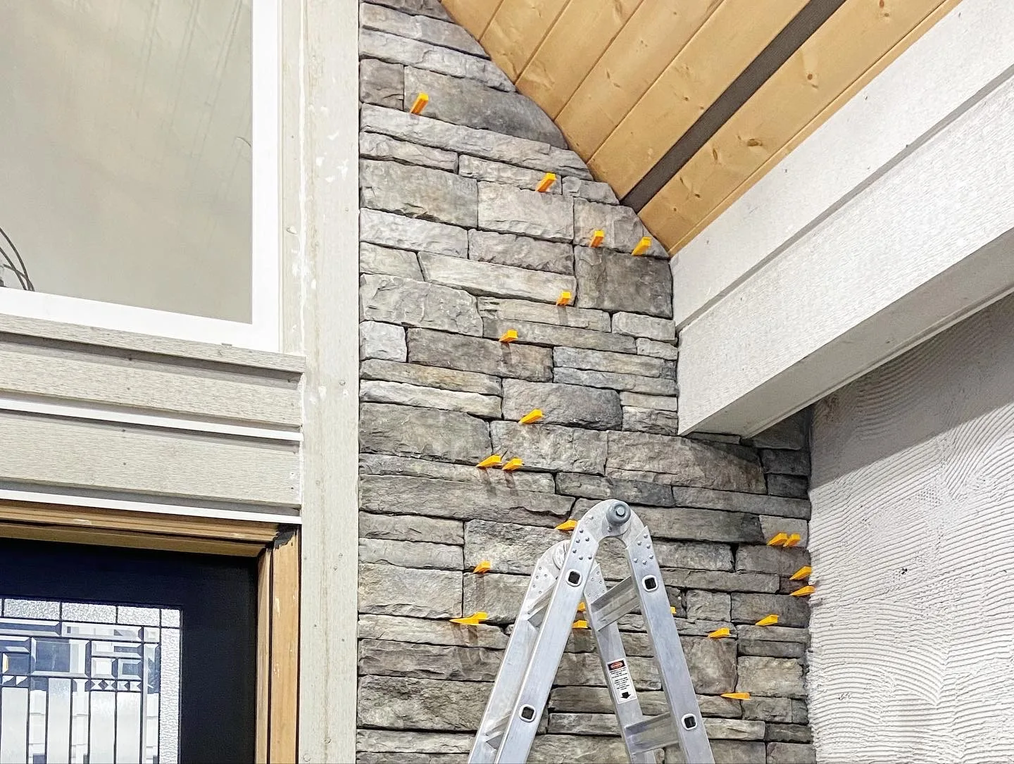 Stone veneer entry surround during installation